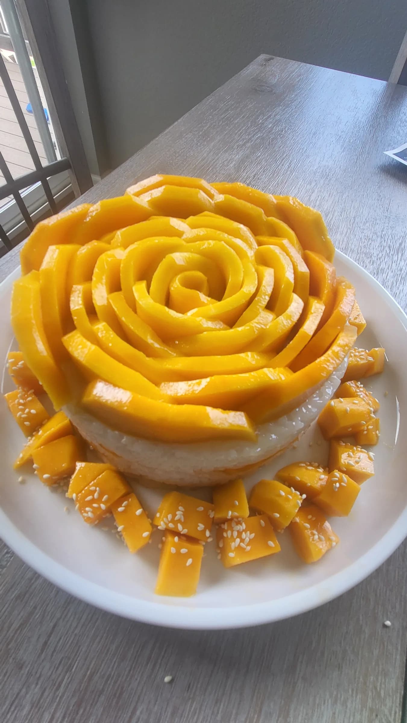 Mango sliced and coiled into a rose