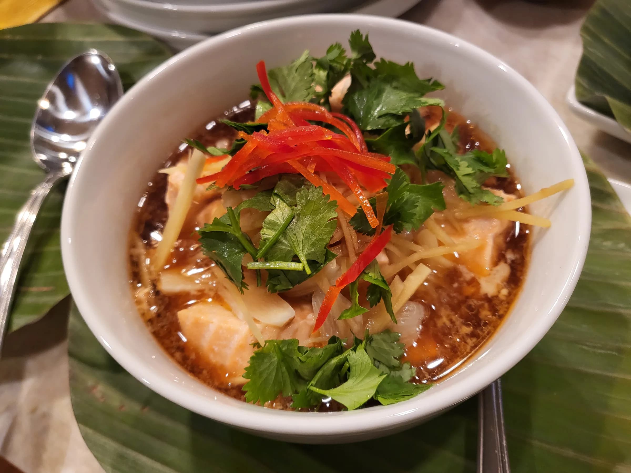 A soup with chili, coriander and shredded ginger