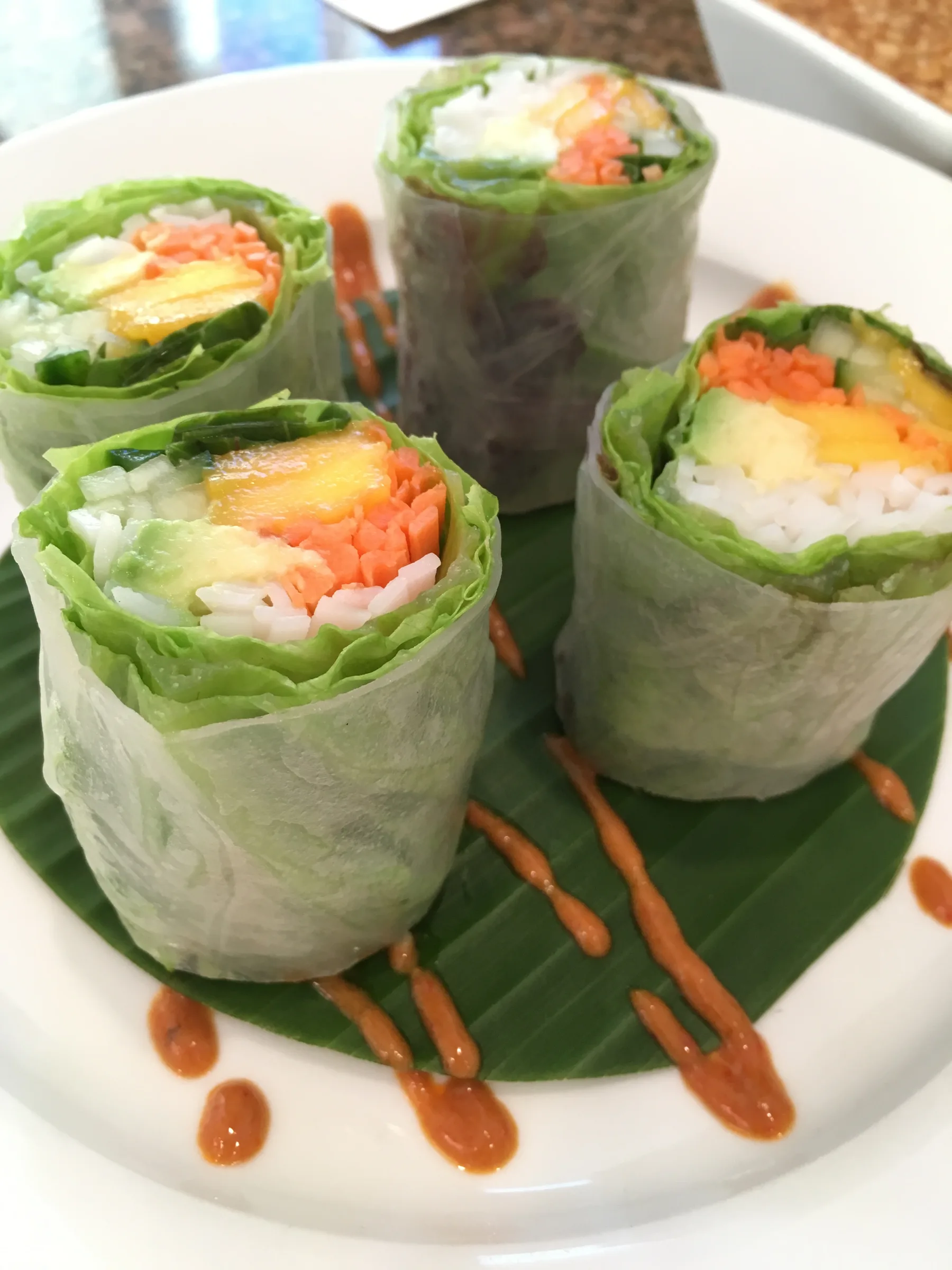 Summer Rolls (Po Piak Sod) standing cut side up on a banana leaf